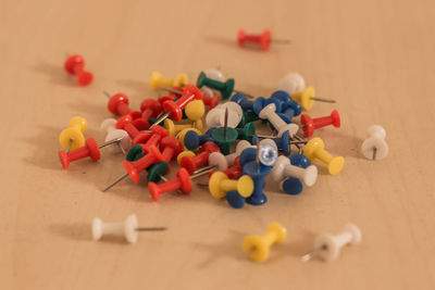 Close-up of multi colored thumbtack on table