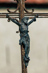 Low angle view of statue against fence