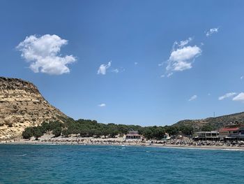 Scenic view of sea and buildings against sky