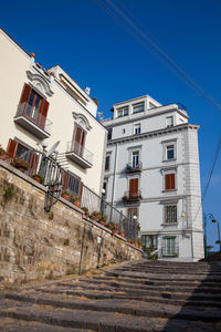 Low angle view of buildings against clear blue sky