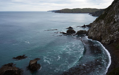 High angle view of calm sea against clouds