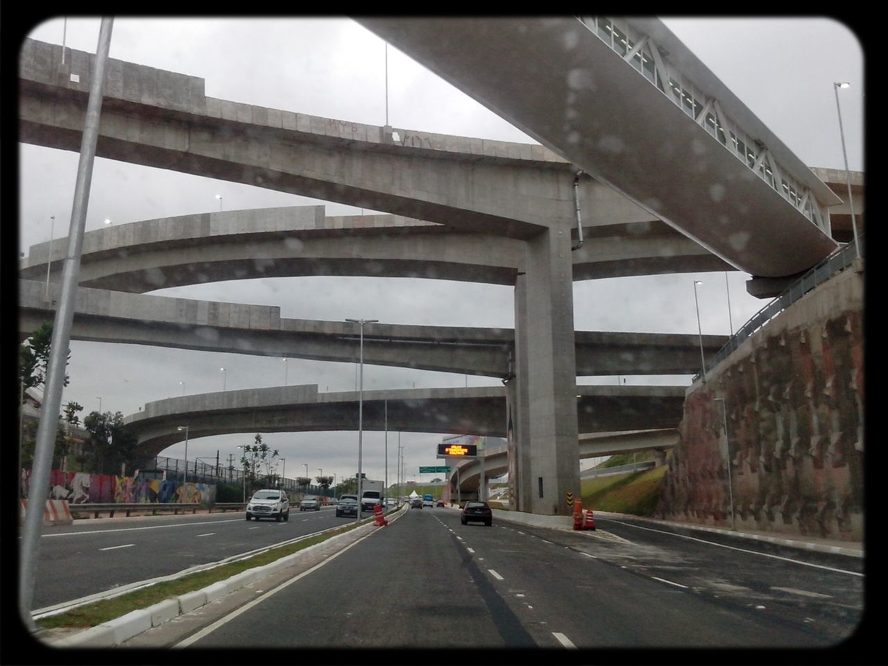 transportation, architecture, road, built structure, car, bridge - man made structure, road marking, the way forward, connection, land vehicle, mode of transport, diminishing perspective, city, sky, street, building exterior, engineering, vanishing point, bridge, highway