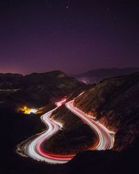 Light trails on winding road at night