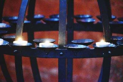 Close-up of illuminated candles on building