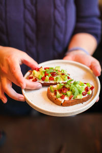 Close-up of hand holding salad