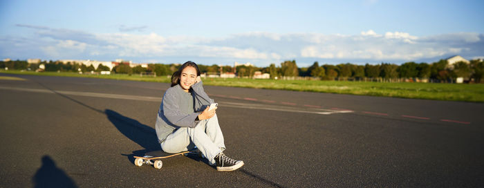 Rear view of woman walking on road