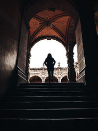 Rear view of people standing on staircase