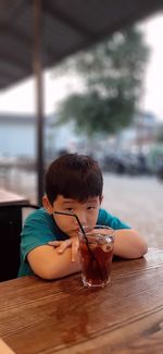 Boy sitting on table