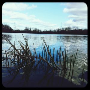 Scenic view of lake against cloudy sky