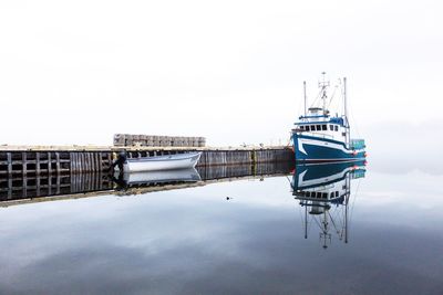 Ship moored in water against clear sky