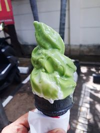 Close-up of hand holding ice cream