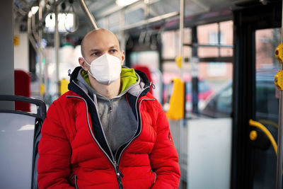 A man in a medical mask in public transport. the concept of the necessary precautions during 
