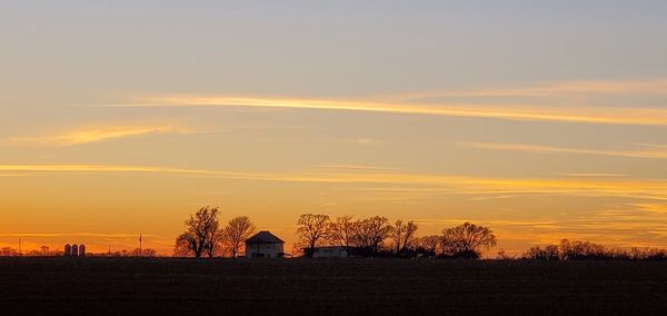 Scenic view of field against sky during sunset