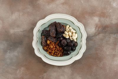 Directly above shot of roasted coffee beans in bowl on table