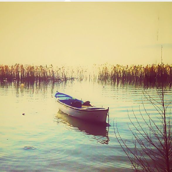 nautical vessel, water, boat, transportation, mode of transport, moored, tranquil scene, reflection, tranquility, lake, waterfront, sunset, scenics, nature, beauty in nature, clear sky, sky, tree, calm, idyllic