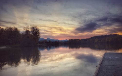 Scenic view of lake against sky at sunset