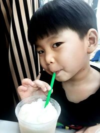 Portrait of boy drinking coffee