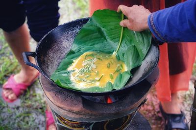 Cropped hand of man preparing food