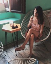 Young woman sitting on chair