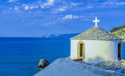 Building by sea against sky