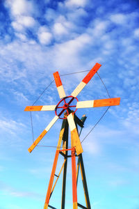 Low angle view of windmill against sky