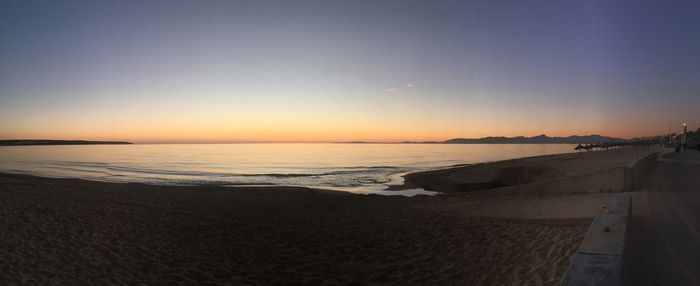 Scenic view of beach against sky during sunset