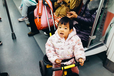 Portrait of cute girl sitting in bus