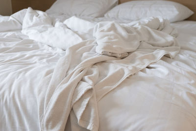 High angle view of messy bed