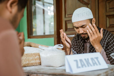 Young men praying together to allah in mosque