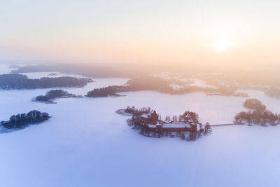 Scenic view of snow against sky during sunset