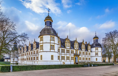 Cathedral by buildings against sky