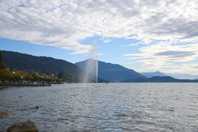 Scenic view of lake against cloudy sky