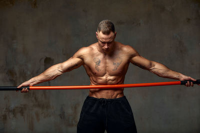 Man holding combat stick in gym