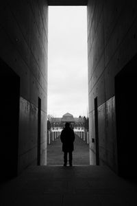 Rear view of people walking in front of building