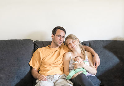 Portrait of family sitting on sofa