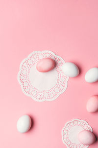 Directly above shot of pills against pink background