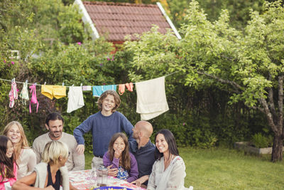 Happy family and friends during garden party in back yard