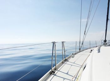 Sailboat sailing on sea against sky