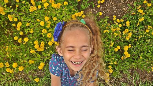 Portrait of smiling woman with yellow flowers