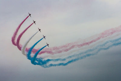 Low angle view of airshow in sky