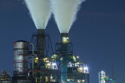 Illuminated buildings against sky at night