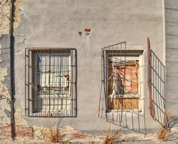 Bolted windows and a walled door on the facade of an abandoned building