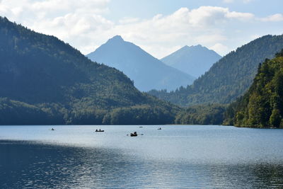 Scenic view of boats in lake against mountain range