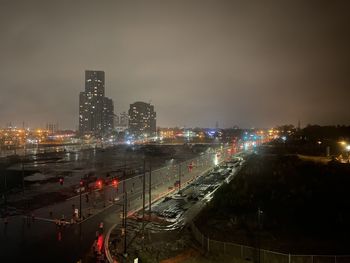 High angle view of illuminated buildings in city at night