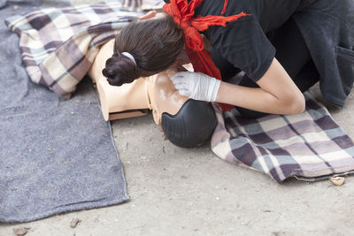 Paramedic performing cpr on mannequin