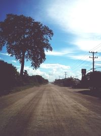 Empty road against cloudy sky