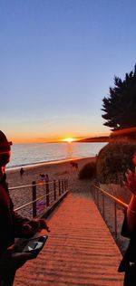 Scenic view of sea against clear sky during sunset