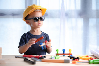 Portrait of boy playing on table