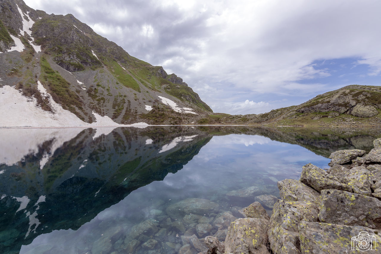 mountain, water, sky, beauty in nature, scenics - nature, cloud - sky, reflection, nature, lake, environment, tranquil scene, landscape, day, tranquility, no people, wilderness, waterfront, scenery, outdoors, mountain peak, mountain range