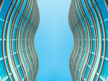 Low angle view of metallic structure against blue sky